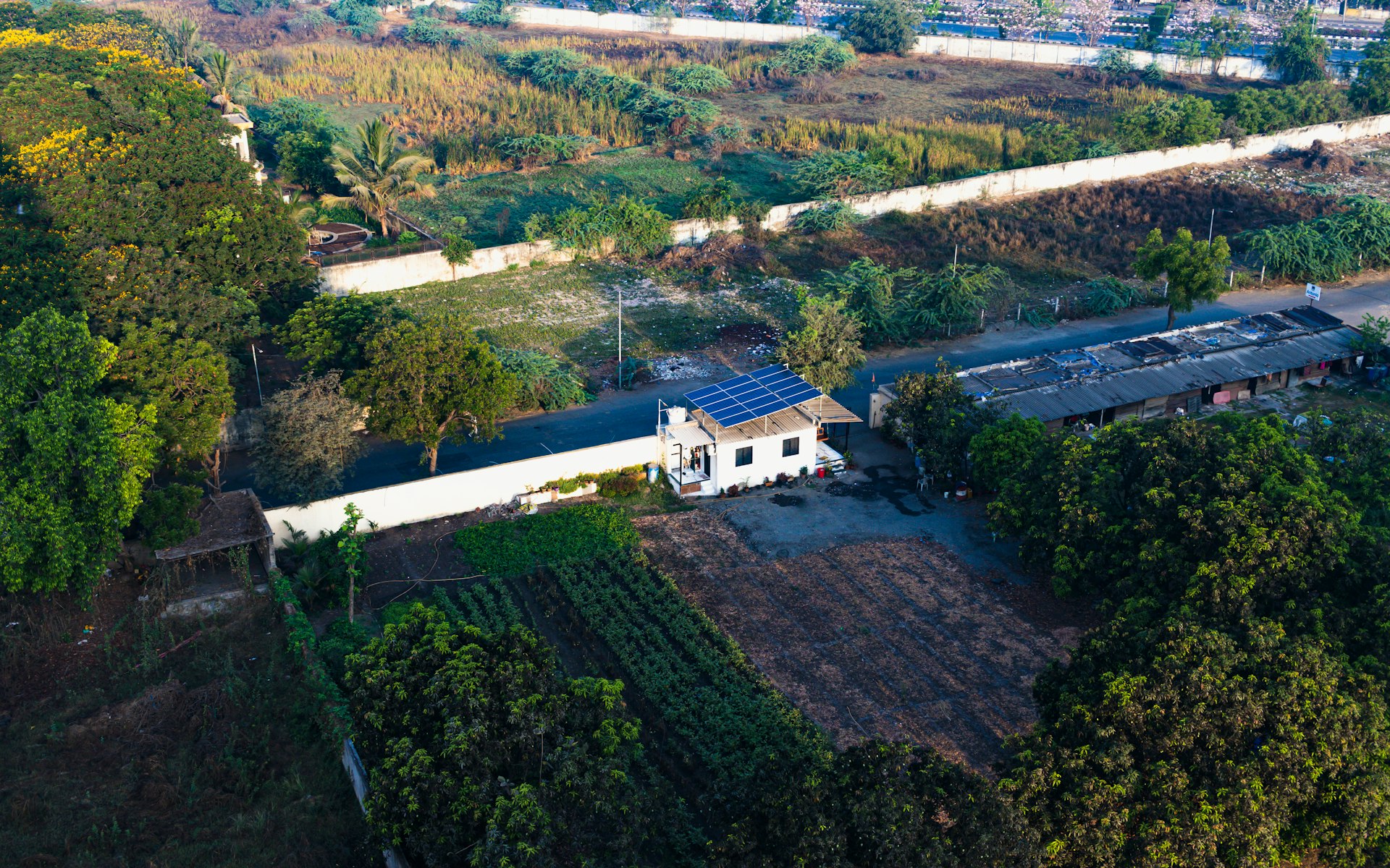 an aerial view of a house with a solar panel on the roof